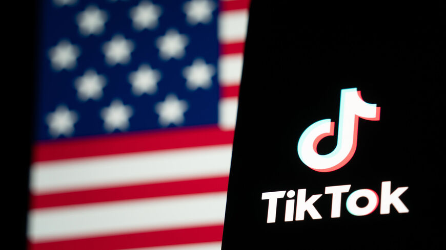 In this photo illustration, the TikTok logo and flag of the United States are seen on screens in Hong Kong, China, Jan. 18, 2025.