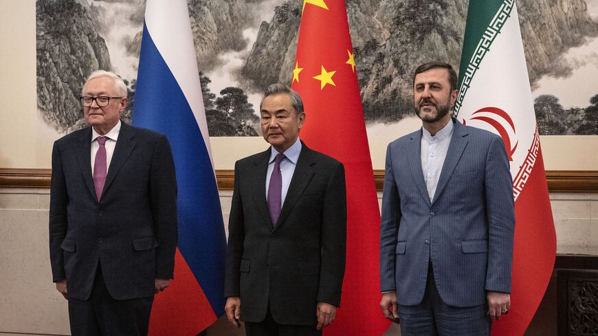 China's Foreign Minister Wang Yi (C) welcomes Russia's Deputy Foreign Minister Sergey Ryabkov (L) and Iran's Deputy Foreign Minister Kazeem Gharibabadi.
