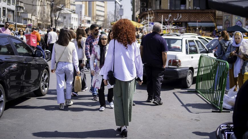 Iranian women walk on the streets, disregarding compulsory hijab law, as Iranians prepare for the Persian New Year that starts with the moment of spring equinox, on March 19, 2025, in Tajrish Square, Iran.