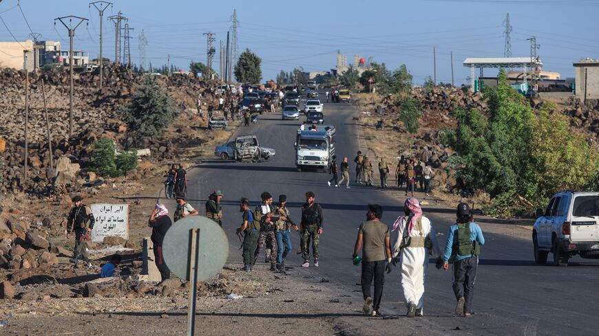 Bedouin and tribal fighters deploy at the western entrance of Syria's Druze heartland of Suwayda on July 18, 2025. 