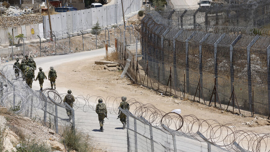 Israeli troops patrol the border fence with Syria near the Druze village of Majdal Shams in the Israel-annexed Golan Heights, July 23, 2025.
