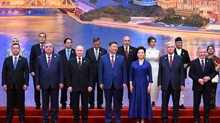 In this pool photograph distributed by the Russian state agency Sputnik, Russia's President Vladimir Putin, Chinese President Xi Jinping, his wife Peng Liyuan and foreign leaders pose during a family photo of the Shanghai Cooperation Organization (SCO) Summit in Tianjin on August 31, 2025. (Photo by Sergei BOBYLYOV / POOL / AFP) (Photo by SERGEI BOBYLYOV/POOL/AFP via Getty Images)