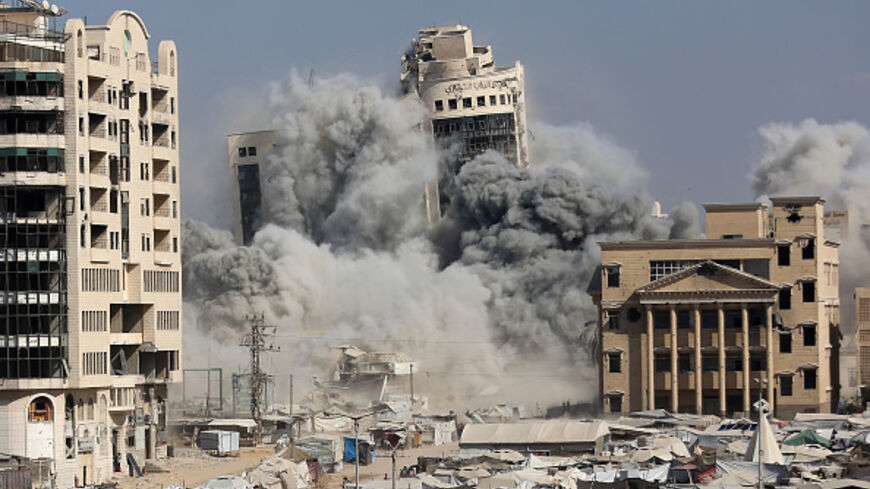 The al-Ruya Tower in Gaza City's Rimal area collapses amidst smoke after Israeli bombardment, on September 8, 2025, following Israel's announcement that it would target tall buildings identified as being used by Hamas ahead of its forces' planned conquest of the urban hub. Israel has been warning for weeks of a new assault on the territory's largest city, without issuing a timeline. It has stepped up air strikes and ground operations on the city's outskirts, sparking fears it could worsen already dire condi