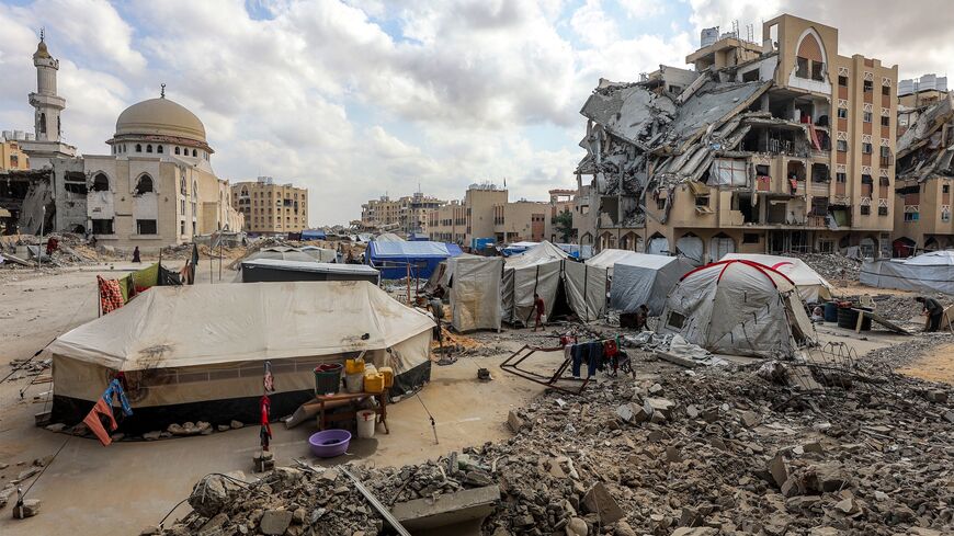 Tents sheltering Palestinians from Gaza City displaced by the Israel-Hamas conflict are pitched by damaged buildings at the Qatari-built Hamad City residential complex, northwestern Khan Yunis, southern Gaza Strip, Sept. 22, 2025.
