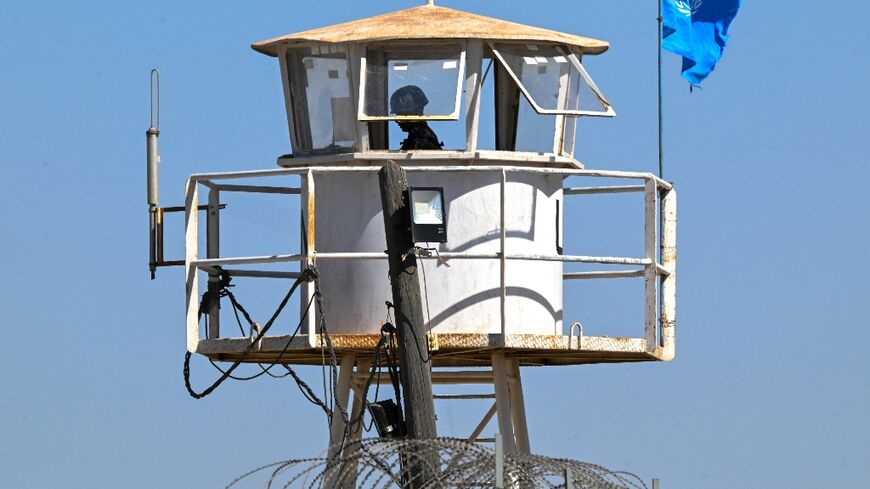 A UN Disengagement Observer Force soldier stands guard at an observation post in the city of Quneitra near the border with the Israeli-annexed Golan Heights in southern Syria