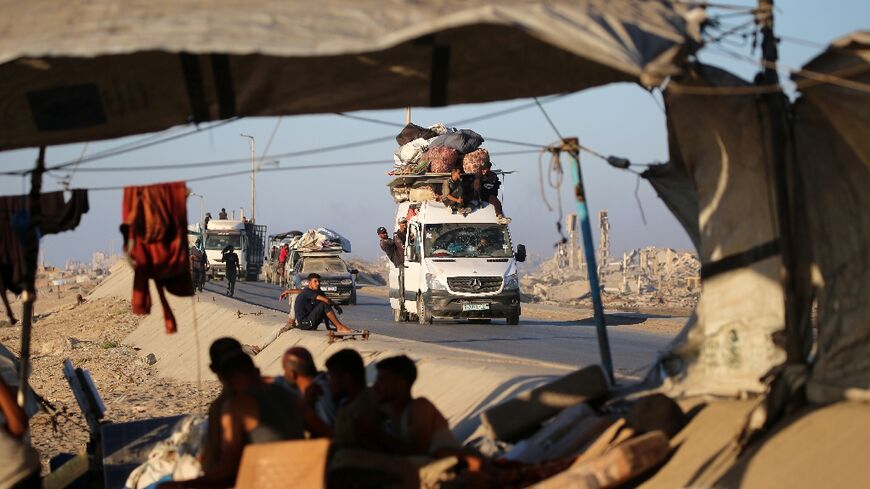 Palestinians flee Gaza City in vehicles piled high with their belongings, passing already crowded tents by the roadside.