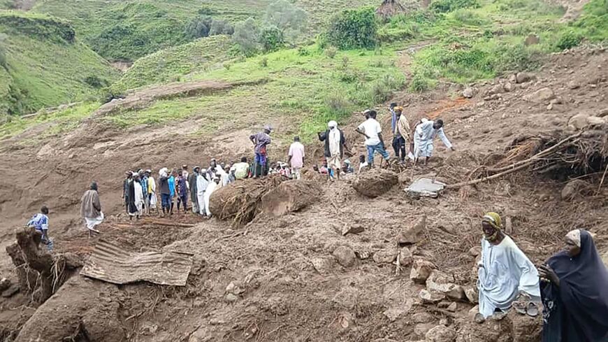 People inspect the debris following a landslide that devastated the village of Tarasin, in Sudan's Jebel Marra area, on Sept. 2, 2025.
