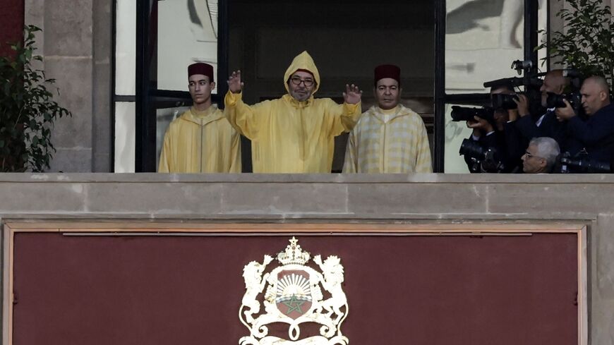 Morocco's King Mohammed VI, accompanied by his son, Crown Prince Moulay Hassan (left), appears on the balcony of parliament headquarters before chairing the opening legislative session
