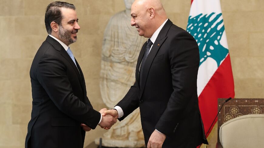 Lebanon's President Joseph Aoun greets Syria's Foreign Minister Asad al-Shaibani before a meeting at the presidential palace in Baabda, east of Beirut