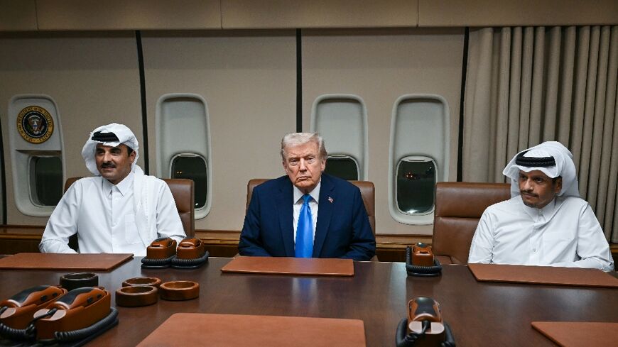 US President Donald Trump meets Qatar's Emir Sheikh Tamim bin Hamad Al-Thani (L) and Prime Minister Sheikh Mohammed bin Abdulrahman bin Jassim Al-Thani (R) aboard Air Force One