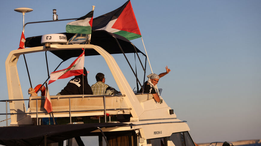 A woman gesture aboard a boat, part of the Global Sumud Flotilla aiming to reach Gaza and break Israel's naval blockade, as it sails off Crete island, Greece, September 25, 2025. REUTERS/Stefanos Rapanis
