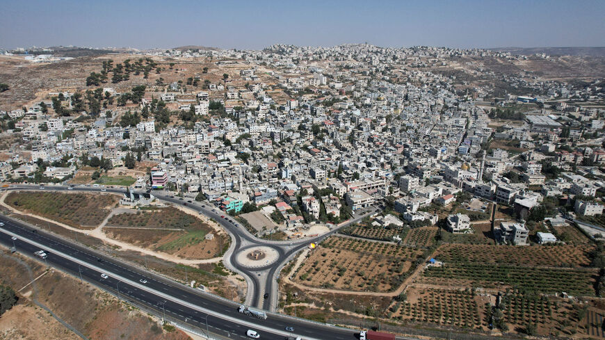 A drone view of Al-Arroub refugee camp alongside a new road, part of the expansion of Israeli bypass roads connecting Israeli settlers in the West Bank with Jerusalem, in the Israeli-occupied West Bank, September 29, 2025. REUTERS/Ammar Awad