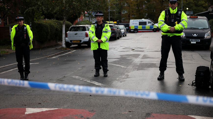 Police officers stand guard at the cordon outside the Manchester synagogue, where multiple people were killed on Yom Kippur in what police have declared a terrorist incident, in north Manchester, Britain, October 3, 2025. REUTERS/Phil Noble