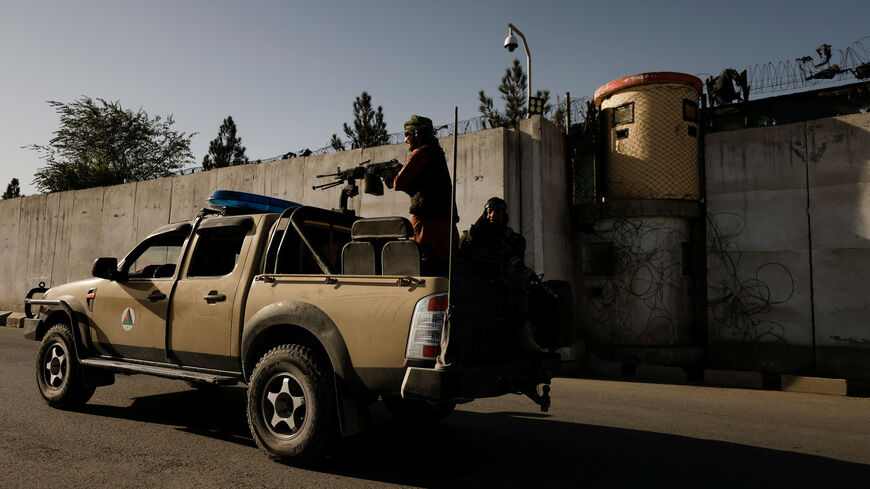 Taliban fighters ride on the back of a pickup truck as they patrol along a road in Kabul, Afghanistan October 23, 2021. REUTERS/Zohra Bensemra