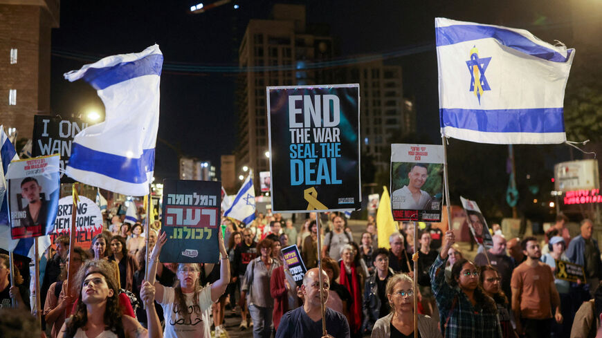 Demonstrators carry flags and placards as families of hostages and their supporters protest ahead of the two-year anniversary of the deadly October 7, 2023, attack on Israel by Hamas, demanding the immediate release of all hostages and the end of the war in Gaza, in Jerusalem, October 4, 2025. REUTERS/Ronen Zvulun     TPX IMAGES OF THE DAY