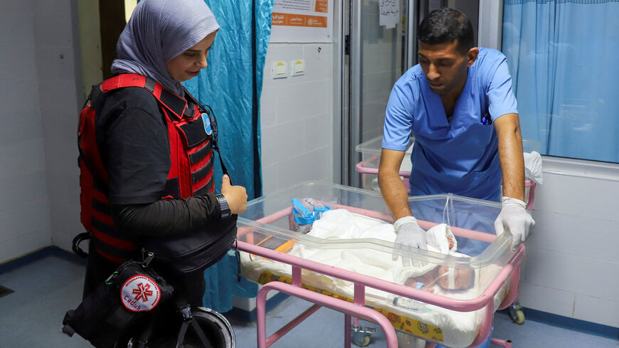 A medical worker prepares to evacuate a premature baby from Al Helo International Hospital to be transported to a hospital in southern Gaza for further medical care, amid an Israeli military operation, in Gaza City October 3, 2025. REUTERS/Ebrahim Hajjaj