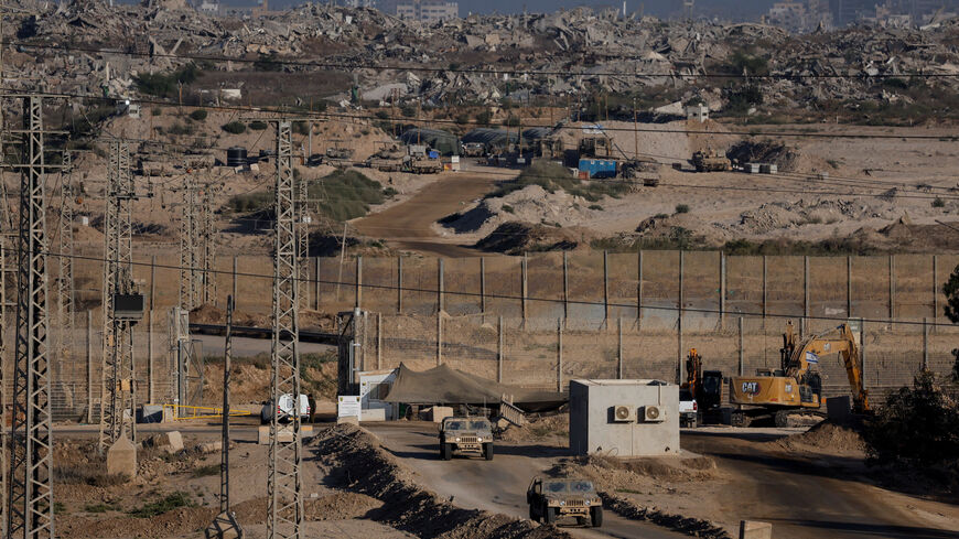 Israeli military vehicles manoeuvre near the Israel-Gaza border, as seen from Israel, September 19, 2025. REUTERS/Ammar Awad