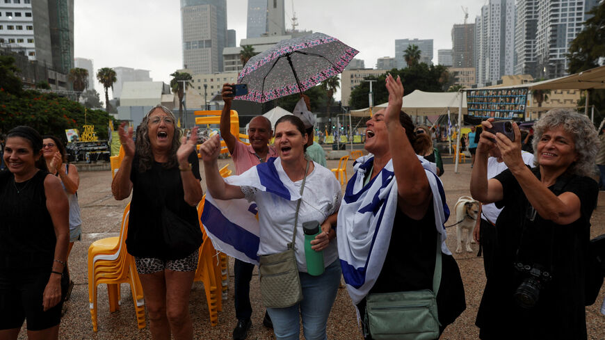 People celebrate after U.S. President Donald Trump announced that Israel and Hamas agreed on the first phase of a Gaza ceasefire, at the "Hostages square", in Tel Aviv, Israel, October 9, 2025. REUTERS/Ronen Zvulun