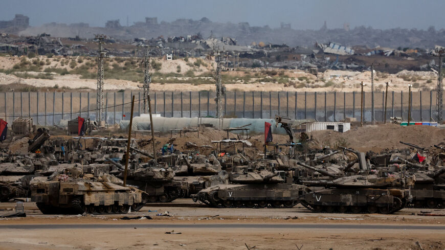 Israeli tanks sit, after U.S. President Donald Trump announced that Israel and Hamas agreed on the first phase of a Gaza ceasefire, on the Israeli side of the border with Gaza, October 9, 2025. REUTERS/Ammar Awad