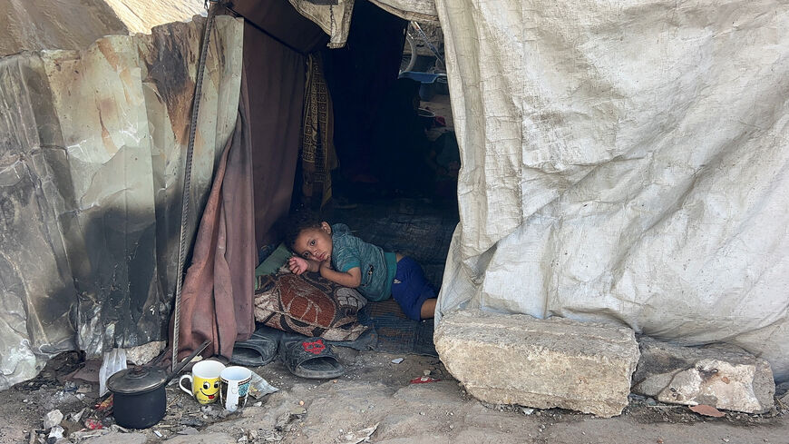 A Palestinian child lies inside the tent he took shelter in with his family after being displaced, in Gaza City May 25, 2025. REUTERS/Stringer