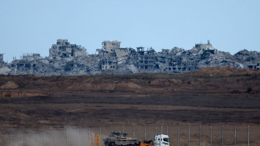 A truck transports an Israeli armoured personnel carrier (APC) near the Israel-Gaza border, after a ceasefire between Israel and Hamas in Gaza went into effect, in Israel, October 10, 2025. REUTERS/Shir Torem