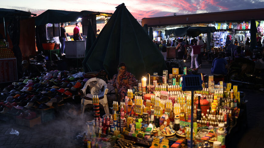 A street vendor sits next to her merchandise in Jemaa el-Fnaa square, in Marrakesh, Morocco, October 21, 2024. REUTERS/Stelios Misinas