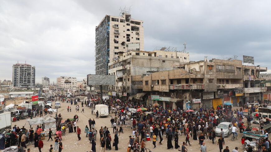 Palestinians gather at a street market during a ceasefire between Israel and Hamas, in Gaza City, October 12, 2025. REUTERS/Ebrahim Hajjaj