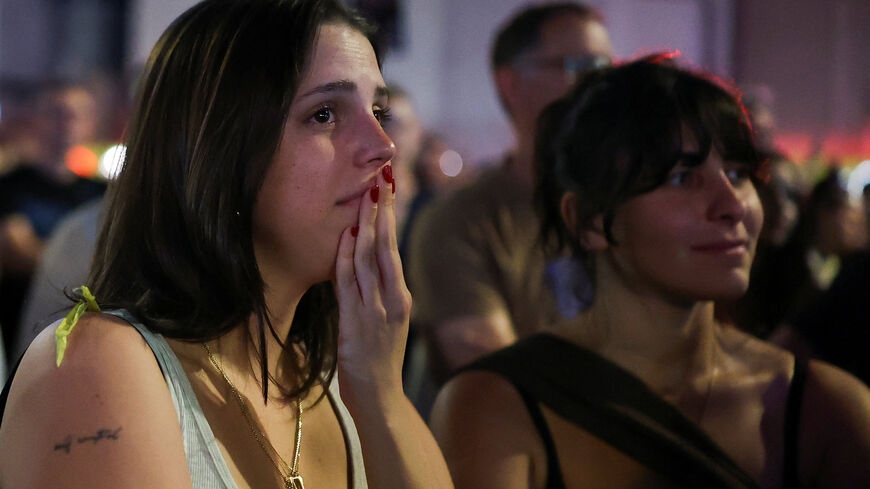A woman reacts as people gather in "Hostages square", after a ceasefire between Israel and Hamas in Gaza went into effect, in Tel Aviv, Israel, October 11, 2025. REUTERS/Hannah McKay