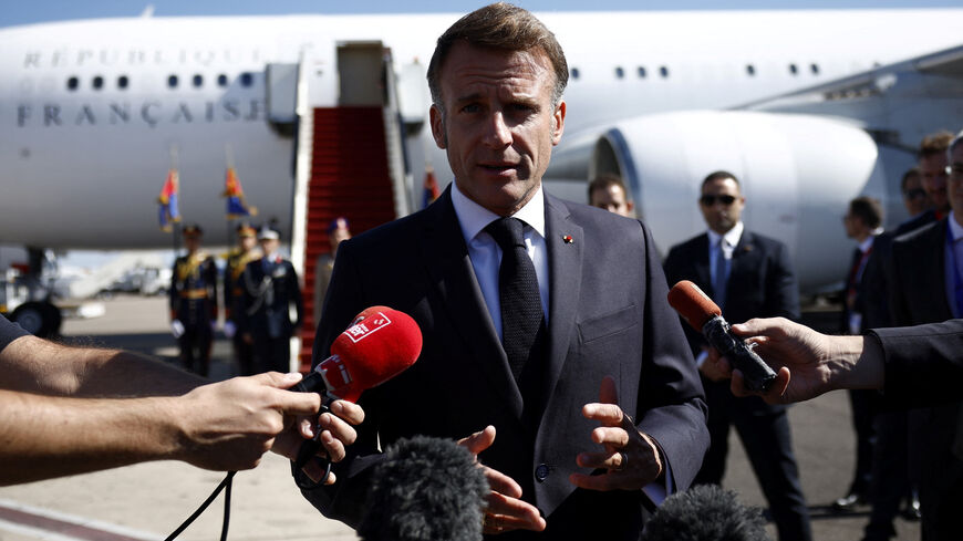 French President Emmanuel Macron speaks to the members of the media, after arriving by plane to attend the Gaza Peace Summit, in Sharm el-Sheikh, Egypt, October 13, 2025. Yoan Valat/Pool via REUTERS