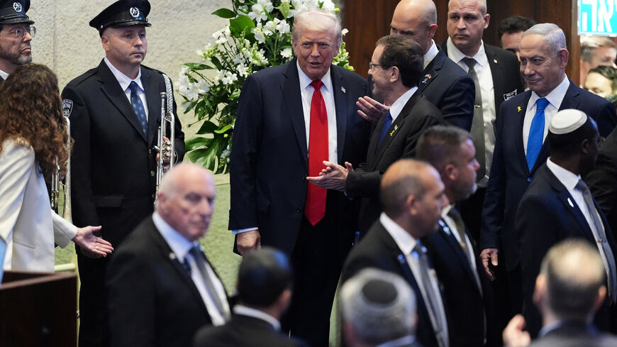 President Donald Trump enters the Knesset with Israel's President Isaac Herzog and Israel's Prime Minister Benjamin Netanyahu, before he speaks, Monday, Oct. 13, 2025, in Jerusalem.     Evan Vucci/Pool via REUTERS