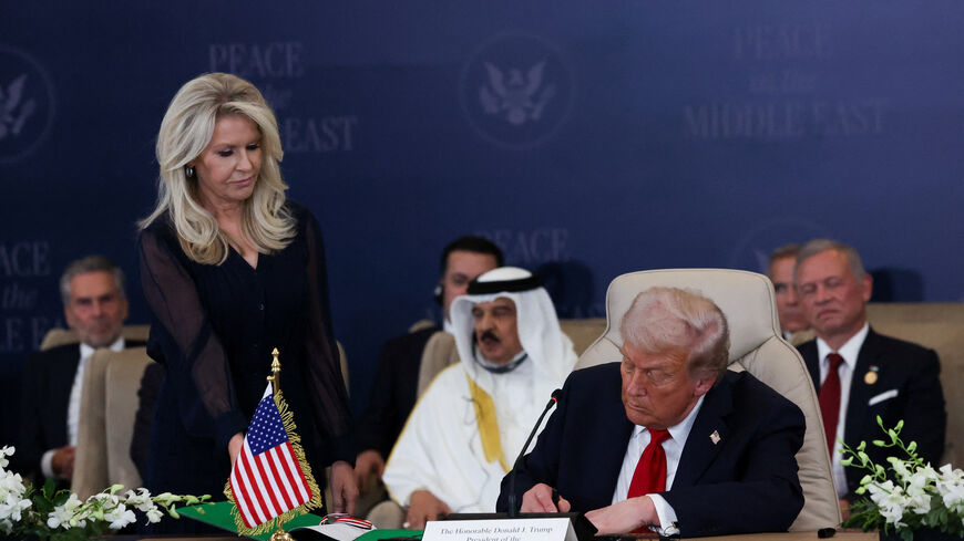 U.S. President Donald Trump signs the agreement at a world leaders' summit on ending the Gaza war, amid a U.S.-brokered prisoner-hostage swap and ceasefire deal between Israel and Hamas, in Sharm el-Sheikh, Egypt, October 13, 2025. REUTERS/Suzanne Plunkett/Pool