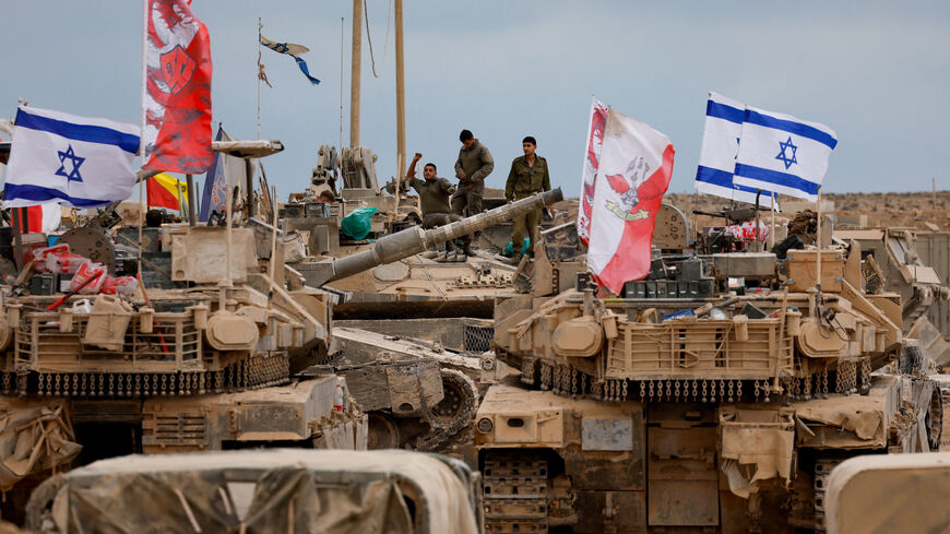 Military vehicles surround Israeli soldiers near the Israel-Gaza border, amid a ceasefire between Israel and Hamas in Gaza, in southern Israel, October 12, 2025. REUTERS/Ammar Awad