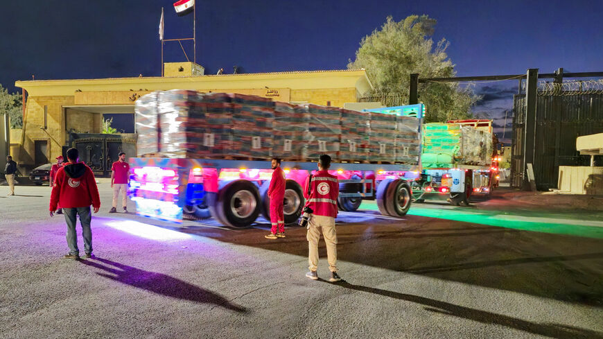 Trucks carrying aid bound for Gaza cross the border crossing between Egypt and the Gaza Strip, after a ceasefire between Israel and Hamas in Gaza went into effect, in Rafah, Egypt, October 12, 2025. REUTERS/Stringer