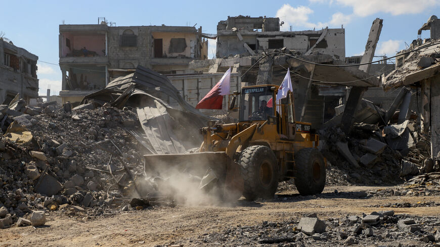 Heavy machinery removes debris from a street, amid a ceasefire between Israel and Hamas, in Gaza City, October 14, 2025. REUTERS/Ebrahim Hajjaj