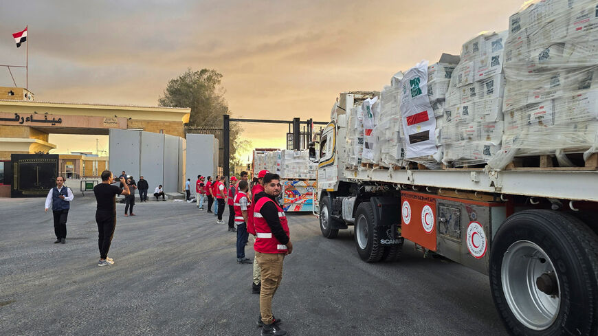 Trucks carrying aid bound for Gaza cross the border crossing between Egypt and the Gaza Strip, after a ceasefire between Israel and Hamas in Gaza went into effect, in Rafah, Egypt, October 12, 2025. REUTERS/Stringer