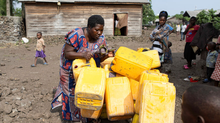 A woman arranges jerrycans as people queue at the standpipe, where incomplete water connections caused by USAID funding cuts to the NGO Mercy Corps have led to ongoing water shortages, in Goma, North Kivu province, Democratic Republic of Congo, June 16, 2025. REUTERS/Arlette Bashizi