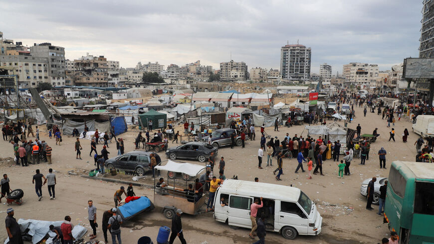 FILE PHOTO: Palestinians gather at a street market during a ceasefire between Israel and Hamas, in Gaza City, October 12, 2025. REUTERS/Ebrahim Hajjaj/File Photo