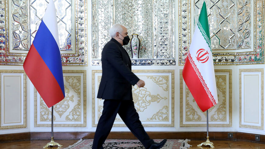 Iran's Foreign Minister Mohammad Javad Zarif passes by the Iranian and Russian flags before meeting with Russia's Foreign Minister Sergei Lavrov in Tehran, Iran April 13, 2021. Iran's Foreign Ministry/WANA (West Asia News Agency)/Handout via REUTERS