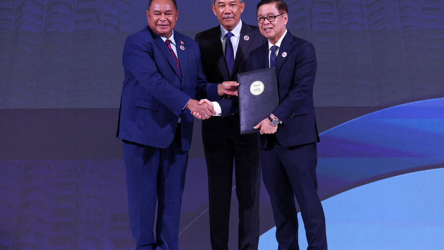 Timor-Leste's Foreign Minister Bendito Freitas, Malaysia's Foreign Minister Mohamad Hasan and Thailand's Foreign Minister Sihasak Phuangketkeow attend a ceremony for the accession of Timor-Leste to the ASEAN charter in Kuala Lumpur, Malaysia October 25, 2025. REUTERS/Chalinee Thirasupa
