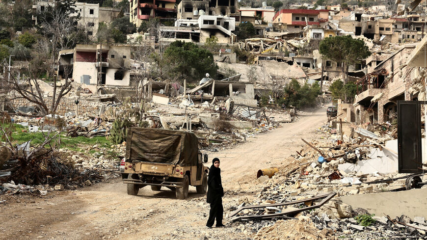 FILE PHOTO: A returning resident walks near a damaged site amid destroyed buildings, as Israeli troops withdrew from most of south Lebanon, in the southern Lebanese village of Kfar Kila, Lebanon, February 19, 2025. REUTERS/Emilie Madi /File Photo