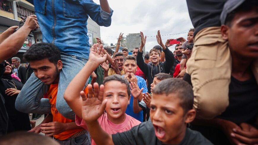 Palestinian children celebrate in Khan Yunis on October 9, 2025, following news of a new Gaza ceasefire deal