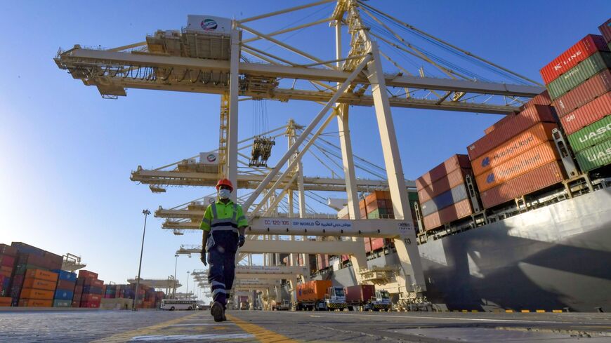An employee wearing a face mask against the coronavirus, is pictured at the port of Jebel Ali, operated by the Dubai-based giant ports operator DP World, in the southern outskirts of the Gulf emirate of Dubai, on June 18, 2020. 