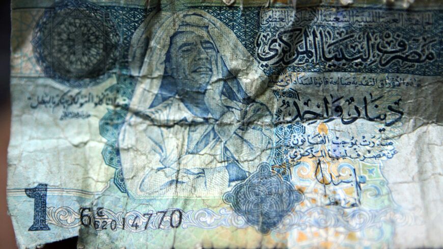Picture of a Libyan dinar banknote bearing a portrait of former leader Moammar Gadhafi is pictured in Tripoli, on Sept. 8, 2011.