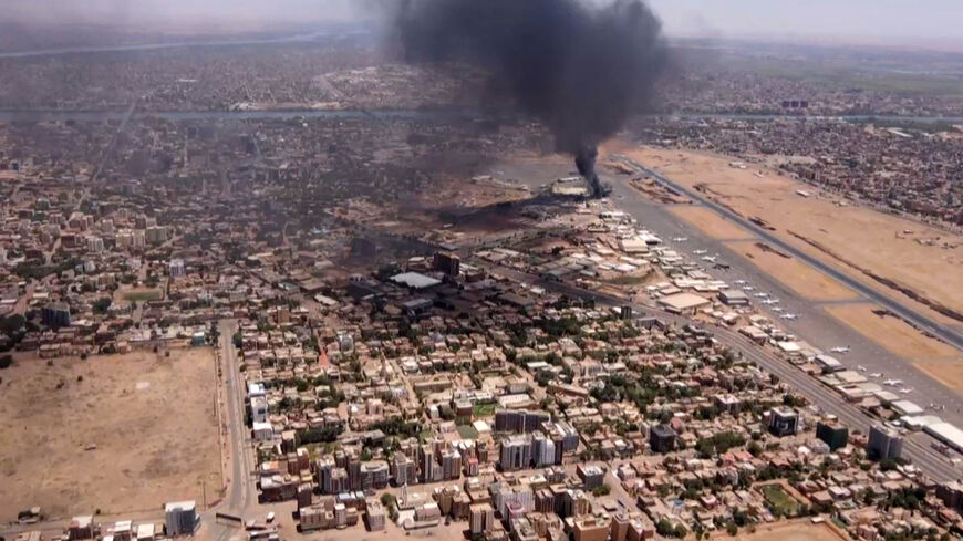 This image grab taken from AFPTV video footage on April 20, 2023, shows an aerial view of black smoke rising above the Khartoum International Airport amid ongoing battles between the forces of two rival generals.