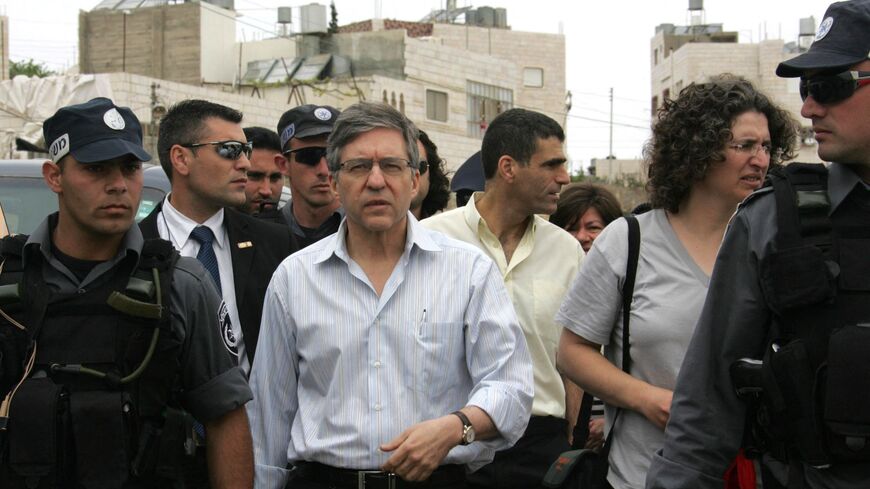 Israeli police escort Israeli former Justice Minister Yossi Beilin.