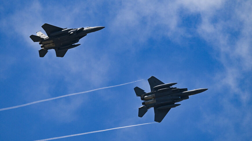 Two F-15 Strike Eagle's take part in an air display on the opening day of the Farnborough International Airshow 2024, south west of London, on July 22, 2024. 