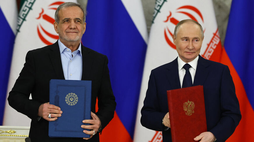 Russian President Vladimir Putin and Iranian President Masoud Pezeshkian sign a strategic partnership treaty during a ceremony following their talks at the Kremlin in Moscow on January 17, 2025. 