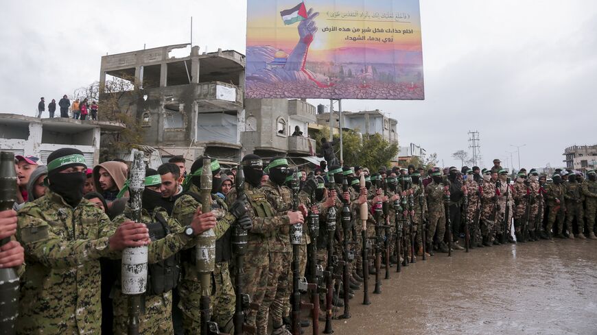Hamas fighters gather at the site of the handing over of two Israeli hostages in Rafah in the southern Gaza Strip on Feb. 22, 2025. 