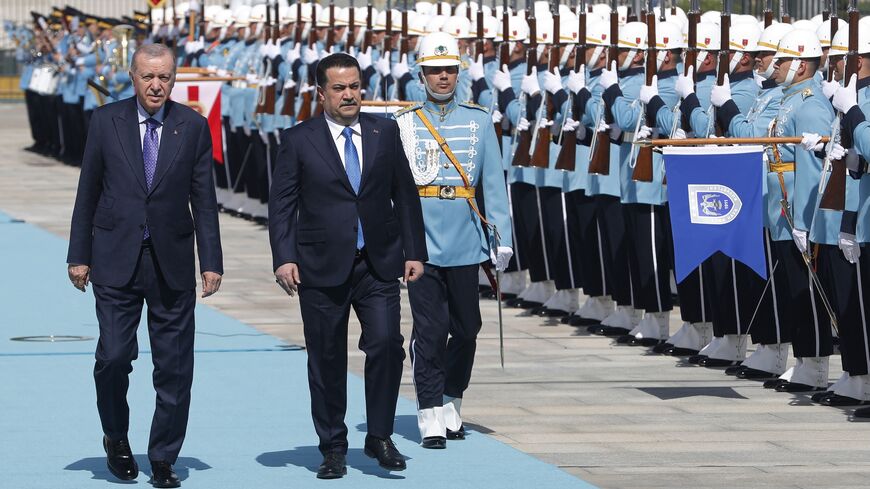 Turkish President Recep Tayyip Erdogan (L) and Iraqi Prime Minister Mohammed Shia al-Sudani review honor guards during the latter's official visit to Ankara, May 8, 2025.