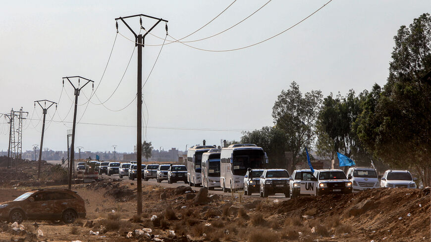 A United Nations convoy evacuating families from Sweida moves through the buffer zone in Busra al-Harir in Syria's southern Daraa province on July 22, 2025. 